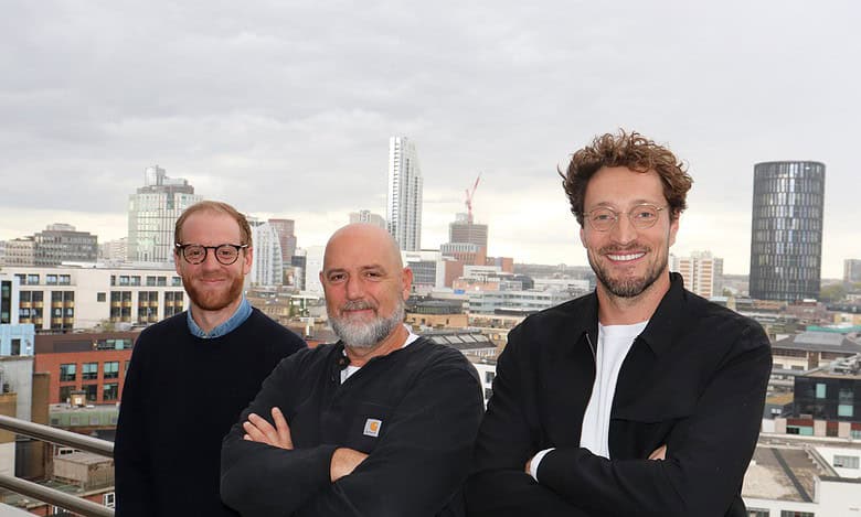 Professional sports analysts on a rooftop overlooking a city skyline, focusing on sports insights, betting tips, and sports commentary for sports enthusiasts and bettors.