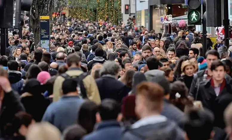 1. A busy city street with a large crowd of pedestrians, highlighting urban foot traffic and public spaces.