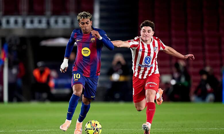 Young football players in action during a competitive match, showcasing skill and determination.