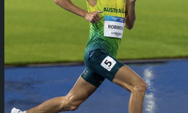 Australian male athlete running on track during the 2026 Glasgow Commonwealth Games.