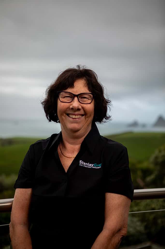 Stanley Gray woman engineer at outdoor site in NZ, smiling in company uniform.