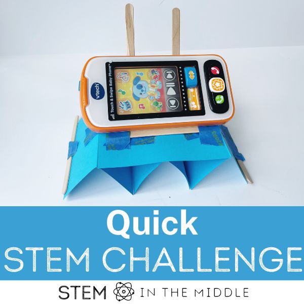 The image reads, "Quick STEM Challenge." The image shows a DIY cell phone stand made from household materials and supporting a toy phone.