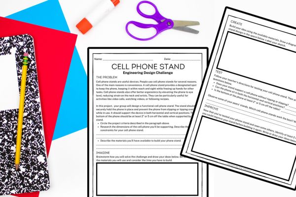 This image shows two worksheets titled "Cell phone stand engineering design challenge." There is a notebook, pencil, scissors, and glue in the background.
