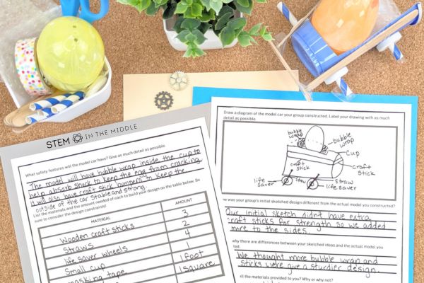 This image shows a car created from a cup, wooden craft sticks, life savers, and straws carrying a plastic Easter egg. The car is above two worksheets. The worksheet shows a completed materials list, a diagram of the car, and reflections on the car's performance.