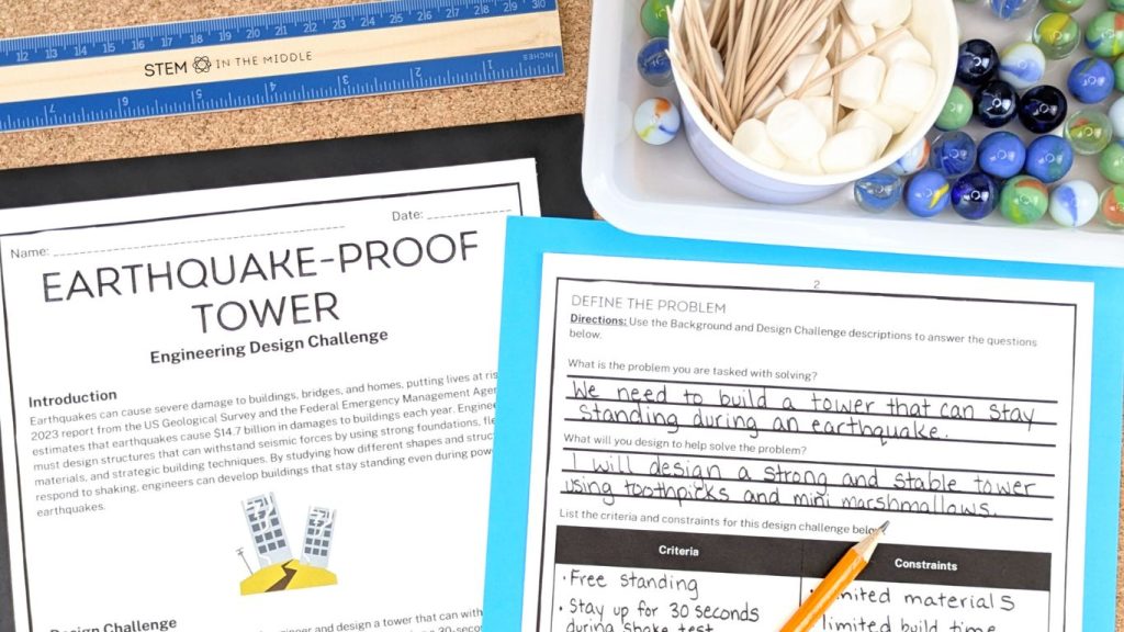 This image shows two worksheets that are part of the "Earthquake Proof Tower STEM Challenge." Above the worksheets are marshmallows, toothpicks, a ruler, and a tray with marbles.