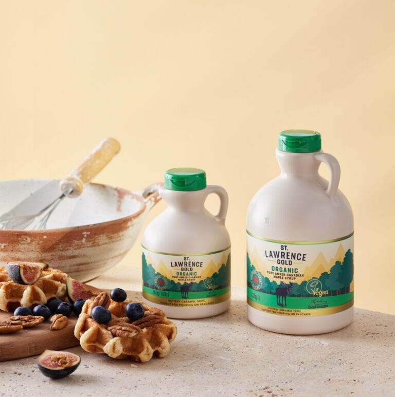 1l and 500ml of organic St.Lawrence Gold maple syrup next to baking materials and waffles, figs and blueberries.