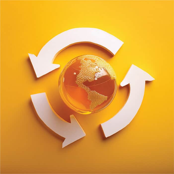 Gold globe with recycling arrows symbolising sustainability and eco-friendly practices.