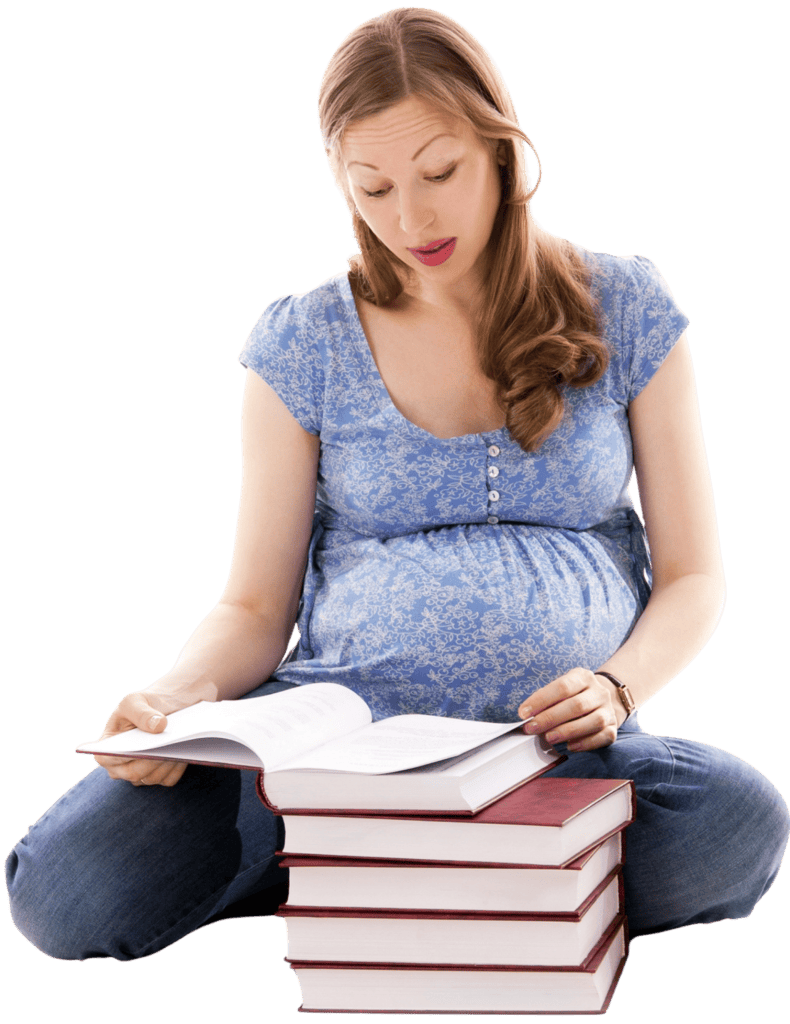 A pregnant woman sitting on the floor studying books