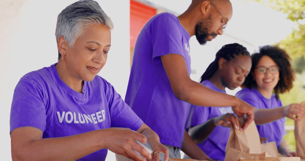 Volunteers packing bags of food for homeless people