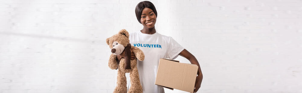 A woman standing with a box of emergency supplies