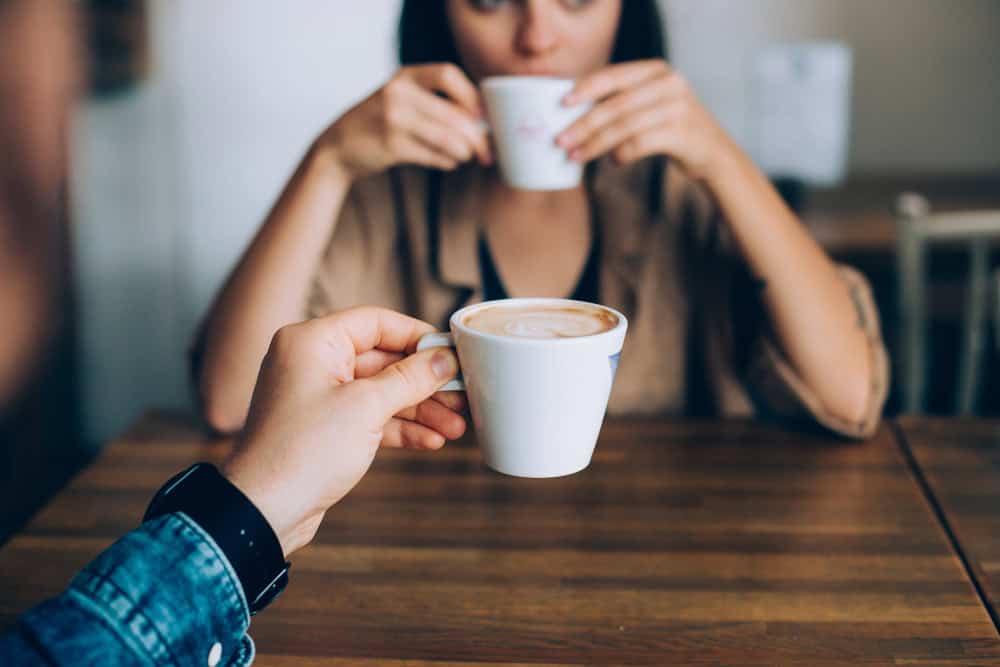 Two women drinking coffee