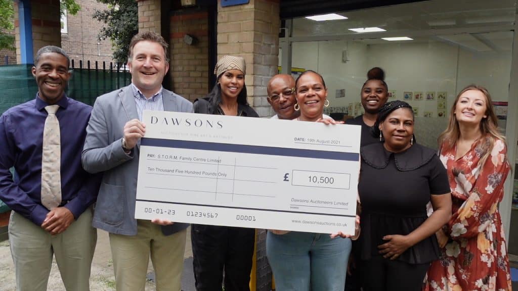 A partner presenting a cheque to STORM founder Marie Hanson for £10000