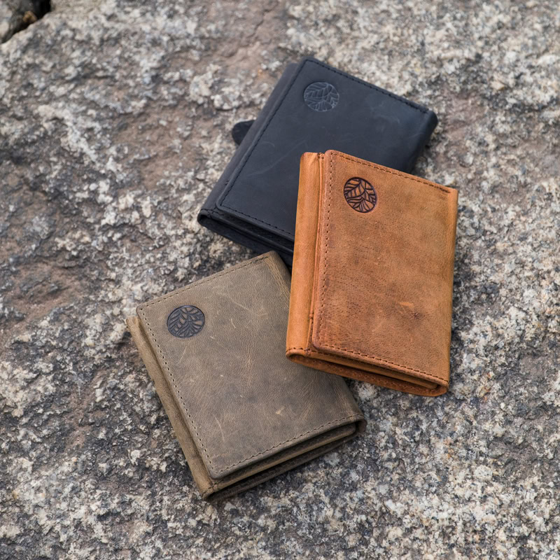 Nurture Nature genuine leather wallets in black, khaki green, and tan – embossed logo