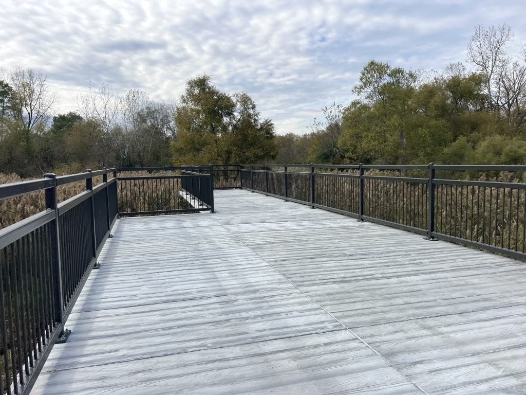 Scenic elevated wooden observation deck surrounded by trees in suburban Chicago.