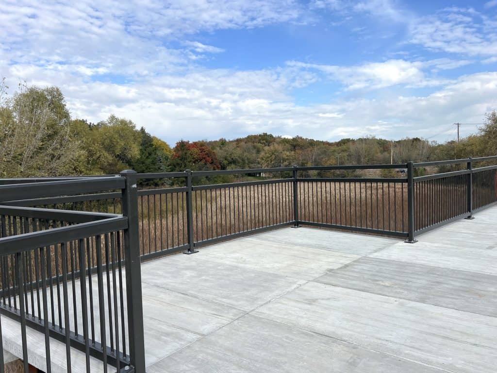 Scenic view from suburban Chicago bike trail overlooking autumn foliage and open skies.