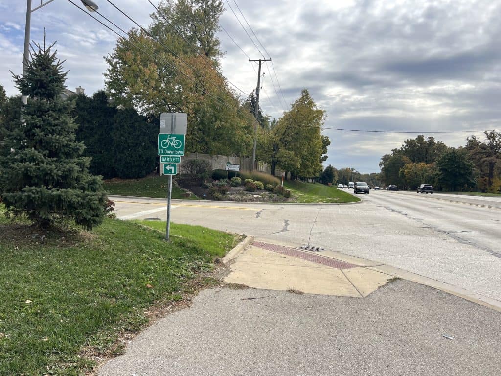 Bike lane sign pointing towards downtown and Bartlett.
