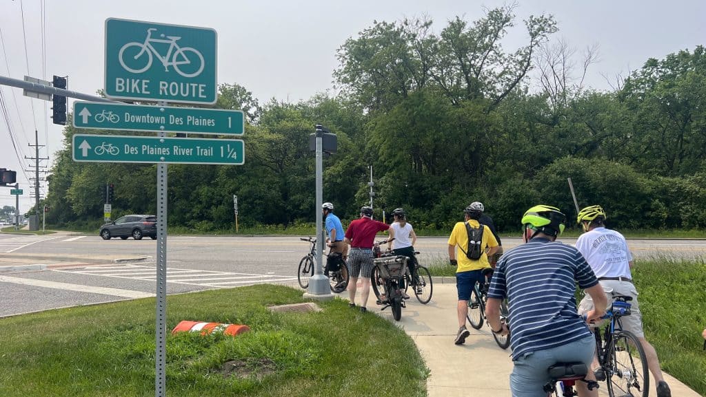 Bicycle group waiting at the intersection on suburban Chicago bike trail.