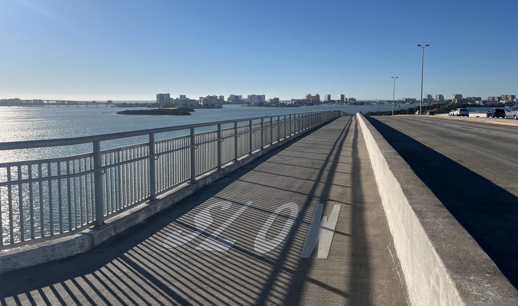 The bridge from downtown Clearwater to Clearwater Beach shows all the buildings, water and sun you can bicycle by — slowly or not.