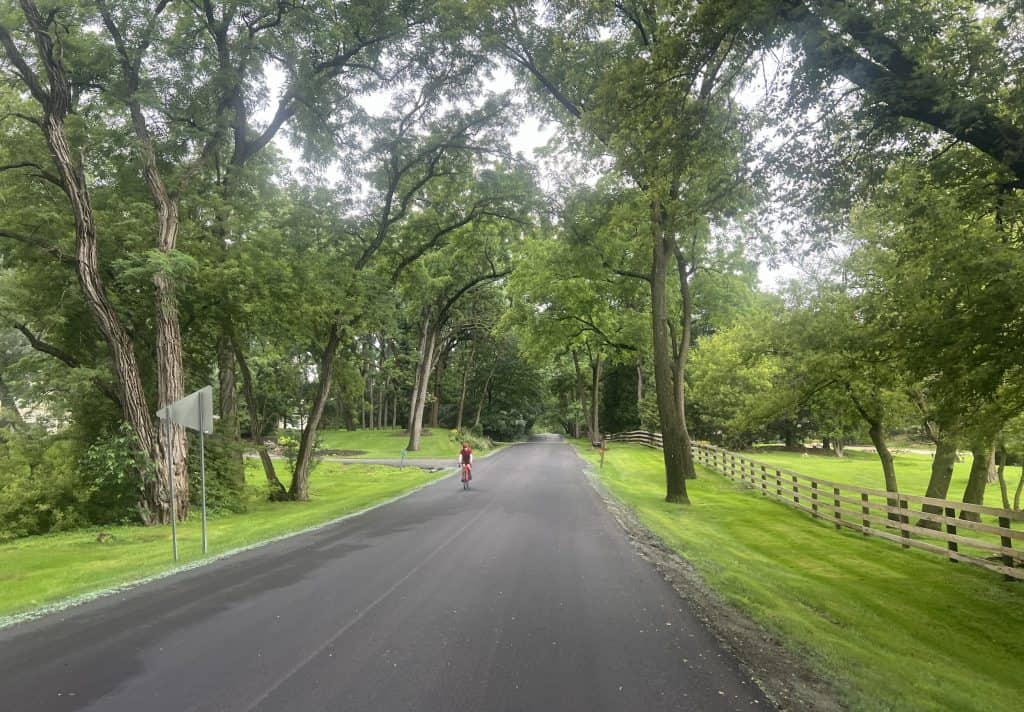 Scenic tree-lined road in Barrington Hills for cycling and outdoor recreation.