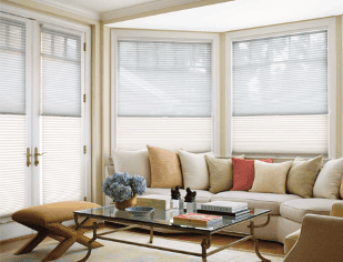 Elegant sun shades window blinds in a cozy living room for stylish light control and privacy.