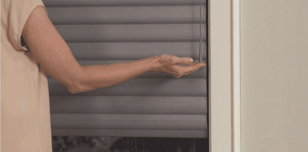 Sun shades window fashions in soft gray, featuring stylish roller blinds for sun control.