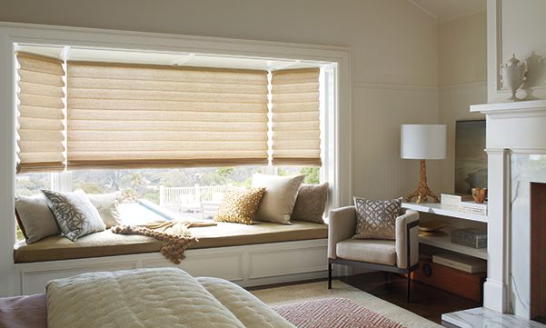 Sun shades window fashions with beige custom blinds for elegant indoor light control and privacy, ideal for living rooms.