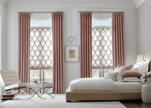 Luxurious window shades with elegant curtains in a modern bedroom setting.