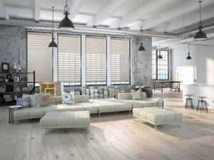 Beige sun shades window fashions in modern industrial apartment setting.