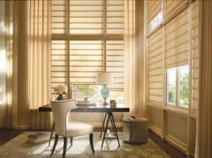 Elegant beige sun shades window fashions controlling natural light in a bright home office.