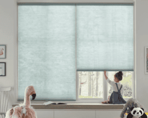 Light blue custom sun shades window fashions for modern home decor and sunlight control.