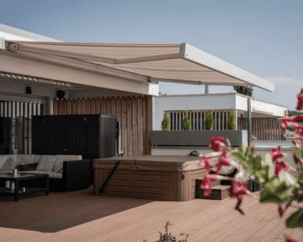 Retractable sun shades on a modern outdoor patio, providing shade and privacy.