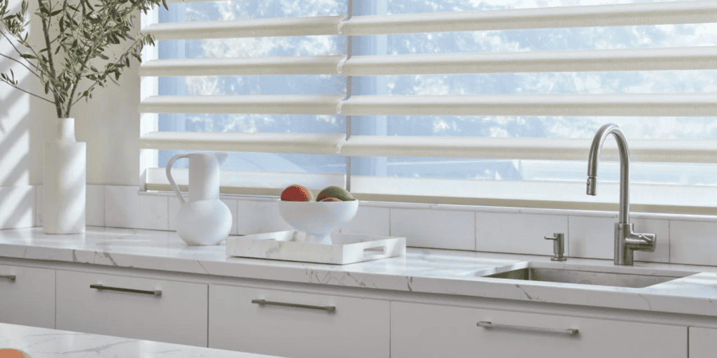 Light-filtering sun shades for kitchen windows with modern design and white frame.
