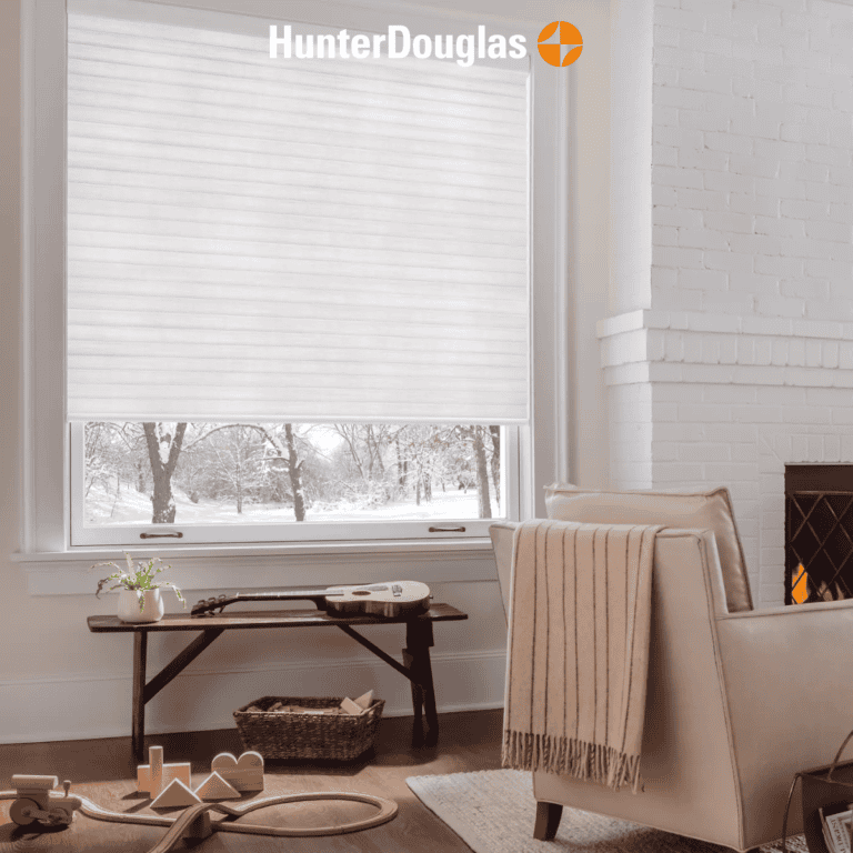 Sun shades window fashions in a cozy living room with white blinds and snow outside.