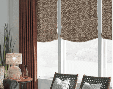 Living room with stylish patterned window curtains and matching drapes, creating a cozy and sophisticated ambiance.