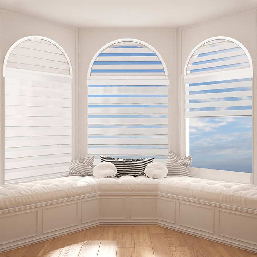Bright window nook with striped blinds and comfortable cushions for relaxing.