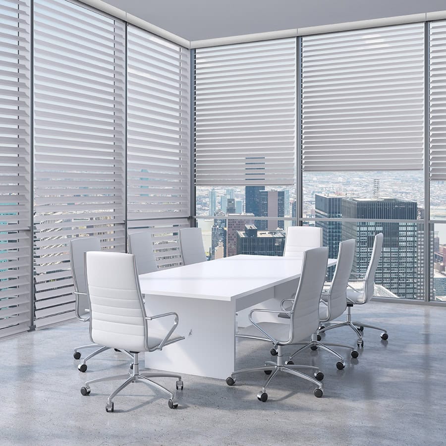 Bright, contemporary office meeting room with large windows and cityscape background, featuring a sleek white conference table and ergonomic chairs for professional gatherings.