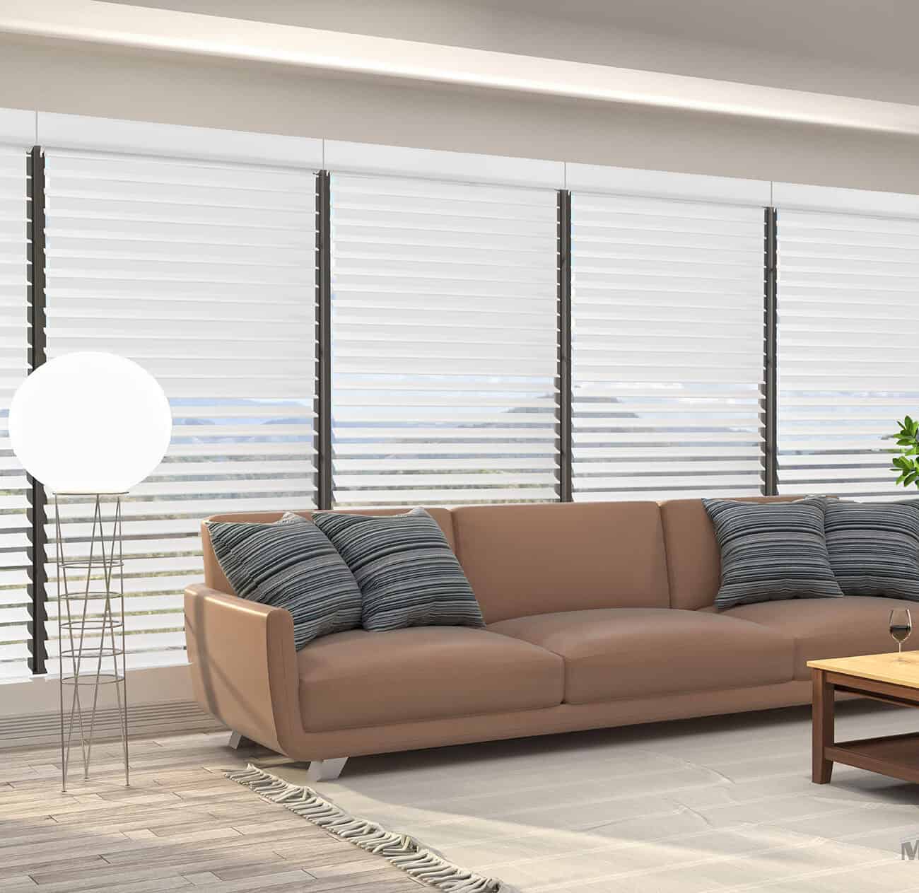 Bright living room with large window blinds, beige sofa, and cozy cushions.