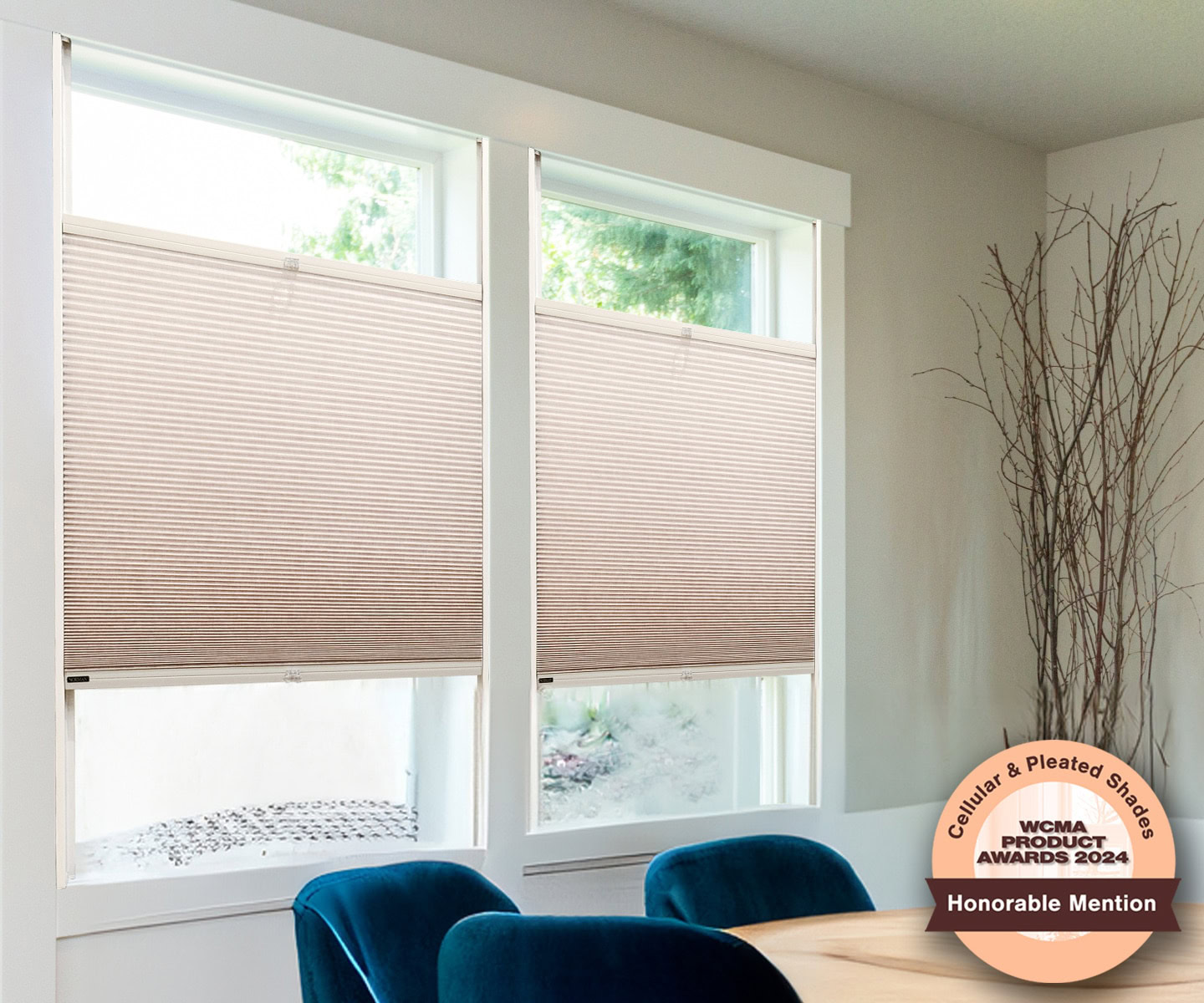 Two large windows with Portrait™ Honeycomb Shades partially lowered, allowing natural light to filter through.