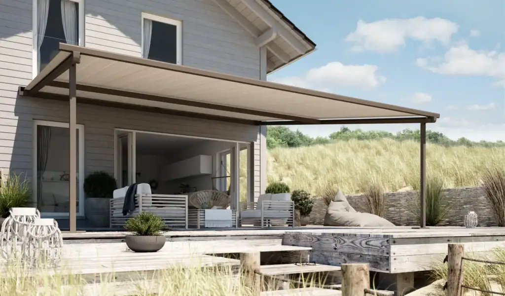 Modern outdoor patio cover by Stobag providing shade and protection for outdoor living space, attached to a contemporary house with large glass doors.