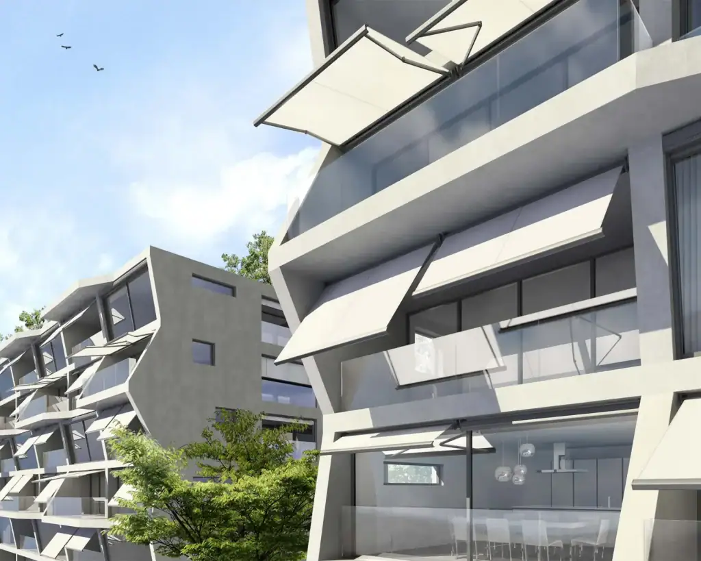 Contemporary apartment complex featuring angular sunshades and large glass windows, surrounded by greenery and a clear blue sky.