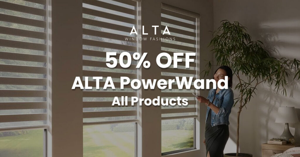 Woman using a remote control to operate ALTA PowerWand window blinds in a modern living room with large windows and natural light.