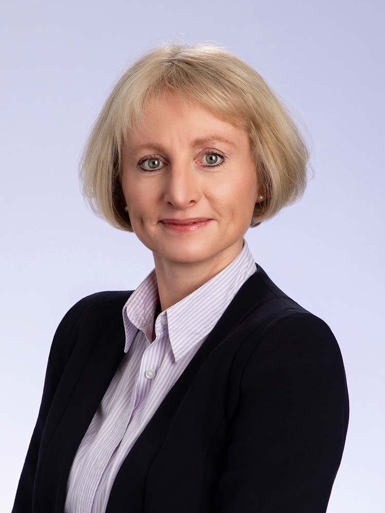 Professional headshot of middle-aged woman with blonde hair in business attire for Sussex headshots, corporate photography, professional portraits, Sussex photography services.