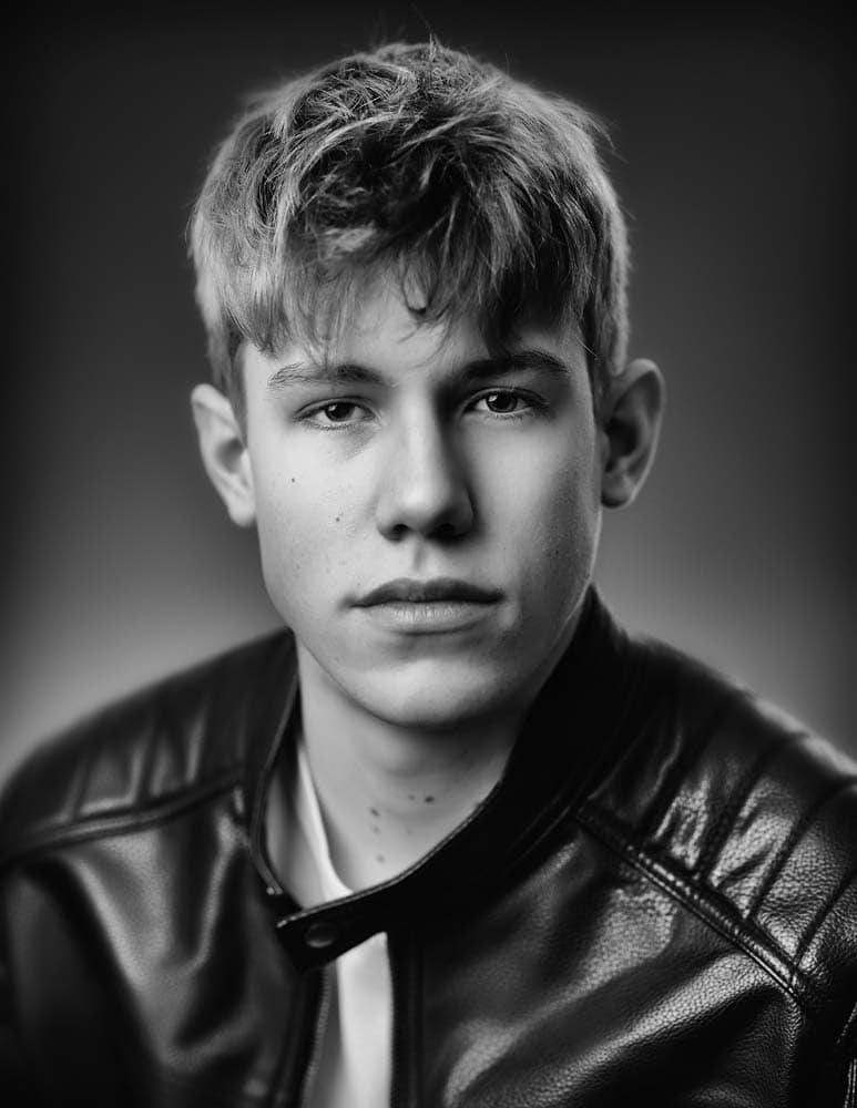 Young man portrait in black and white for professional headshots in Sussex, showcasing confident and authentic expressions. Ideal for corporate, LinkedIn, and personal branding photoshoots.