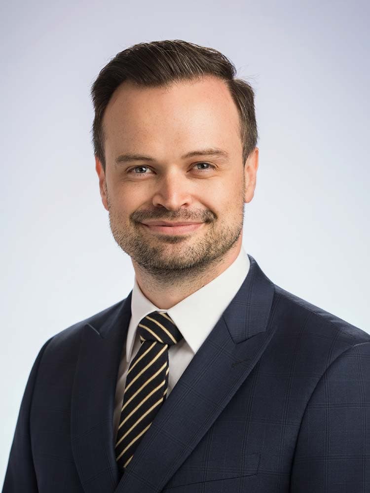 Business headshots in Sussex. Professional headshot of a confident businessman in a navy suit and striped tie, ideal for corporate profiles and LinkedIn in Sussex.