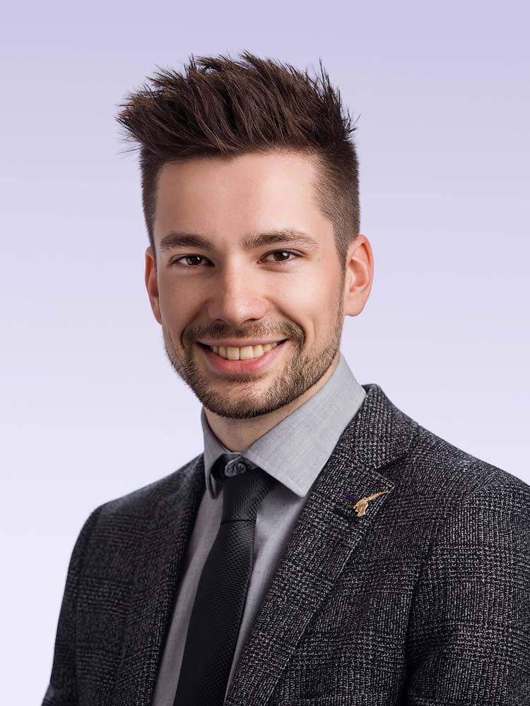 Professional Sussex headshot of a young man in formal attire for business profile or corporate branding.