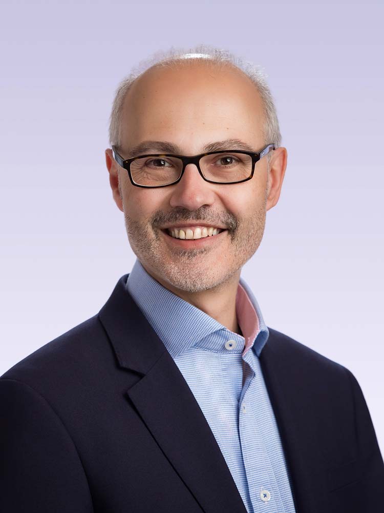 Professional Sussex headshot of a confident businessman in a suit, ideal for corporate, LinkedIn, and professional profiles. High-quality business portrait photography.