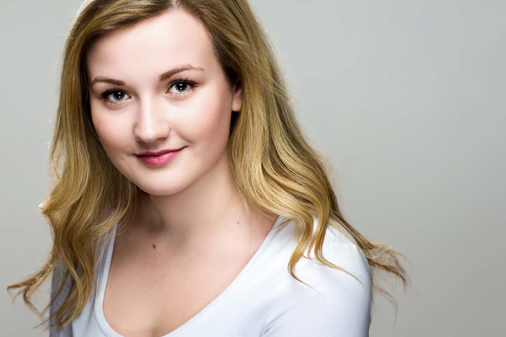 Sussex headshots gallery. Bright young woman with blonde hair in professional headshot for corporate or LinkedIn profiles, Sussex Headshots photography.