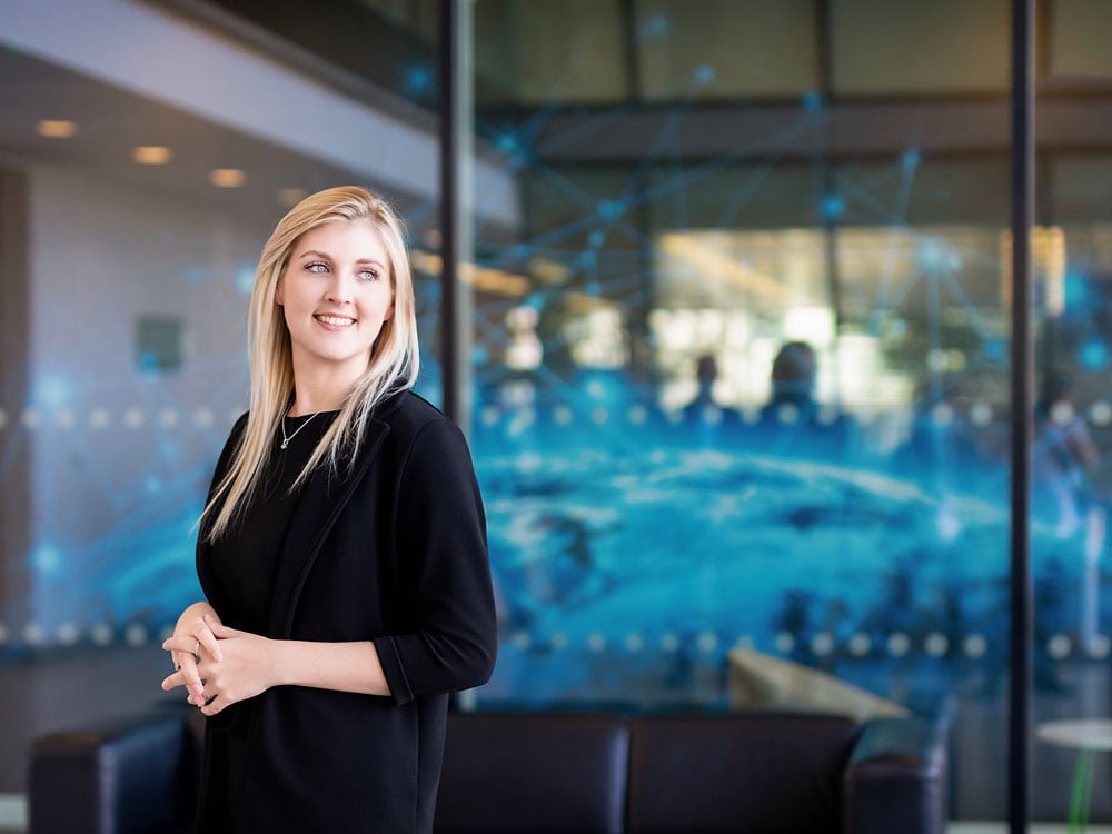 Bright professional headshot of a smiling woman in business attire at Sussex Headshots, showcasing confident corporate photography services in Sussex.