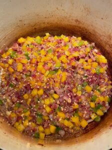 Sauteeing bell peppers, onions, and garlic in a dutch oven