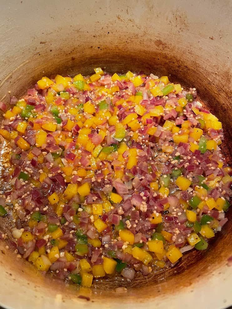 Sauteeing bell peppers, onions, and garlic in a dutch oven
